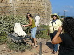 Natalia, Ann, and Ursula, goofing with the giant foot in Ceasarea (rw)