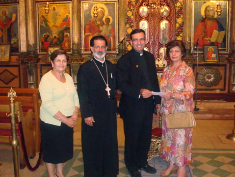 Father Samer presenting donation at church in Ramallah? (sy)