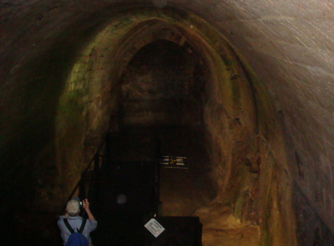 Robert setting up to take picture of the depths of the cistern at the Struthion Pools, Antonio Fortress (hs)