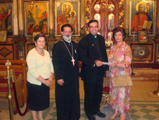 Father Samer presenting donation at church in Ramallah? (sy)