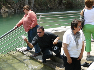 Father Samer blessing us with water from the River Jordan, with Ann and oum Fadi (rw)