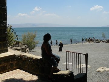 Nicole contemplates the Sea of Galilee from the steps of the Church of St Peter's rock (rw)