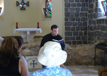 Father reads the gospel about St. Peter the rock (rw)