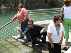 Father Samer blessing us with water from the River Jordan, with Ann and oum Fadi (rw)
