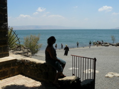 Nicole contemplates the Sea of Galilee from the steps of the Church of St Peter's rock (rw)