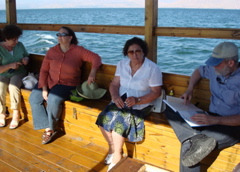 Boat ride on Sea of Galilee - Lilian, Ann, Rafiha, and Robert reading the Illustrated Atlas of Jerusalem (sy)