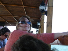 Ann with the wind blowing her hair, on the Sea of Galilee (rw)