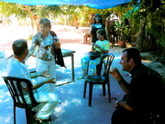 Relaxing with Turkish coffee under a blue tarp at the Druze falafel cafe - Salim, Widad, Alma, Suad, Father Samer (rw)